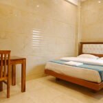 Premium deluxe room at SSK Marina Residency featuring a comfortable double bed, elegant interiors, air conditioning, and modern guest amenities.