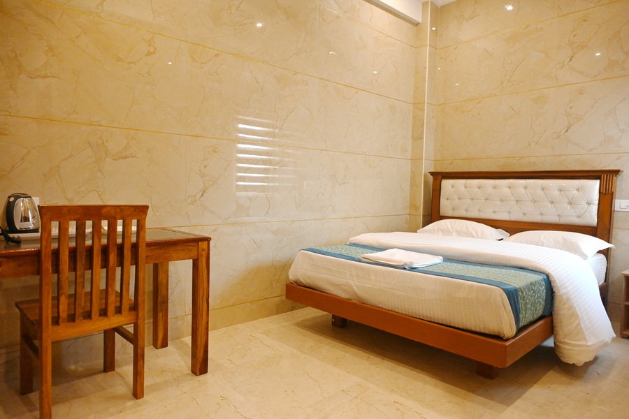 Premium deluxe room at SSK Marina Residency featuring a comfortable double bed, elegant interiors, air conditioning, and modern guest amenities.